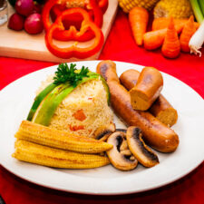 nie table with plate of pilaf rice and sausages