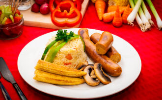 nie table with plate of pilaf rice and sausages