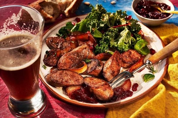 Venison Wild Boar and Pork Bratwurst With beer and salad