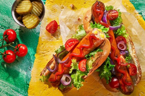 Cheese Frankfurters in Buns with Salad and Garnishes